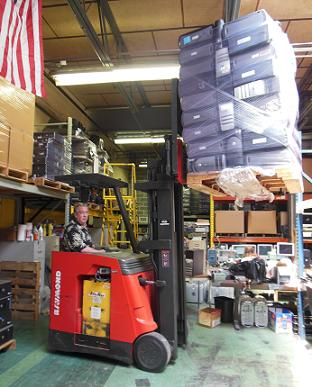 President and founder Robert Toporek moves a pallet of computers, making room for 90 more Dell Pentium 4 desktops